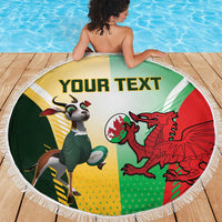 Round beach blanket with fringe, green yellow red sports crests and 'YOUR TEXT'