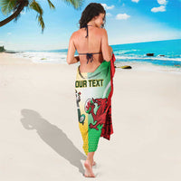 Custom rugby sarong worn as a wrap, showing “YOUR TEXT” and dragon crest on green/red