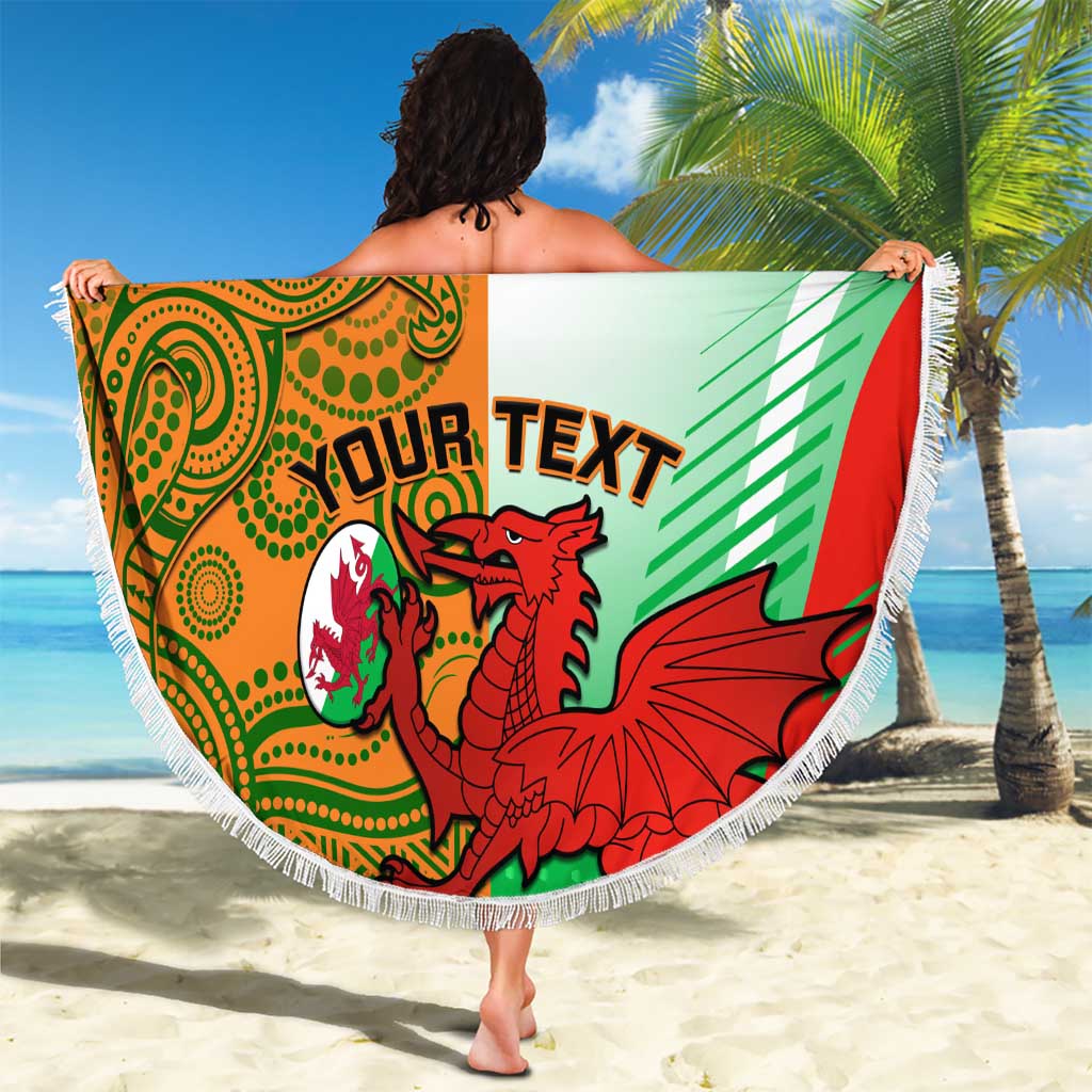 Round beach blanket with fringe, green orange red graphic and custom text held up on sand