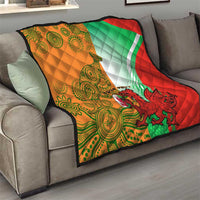 Quilt blanket on couch with red, green, white, and orange pattern; dragon graphic and custom text