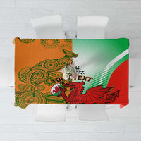 Red and green rugby tablecloth flat lay with crest artwork and diagonal stripe bands
