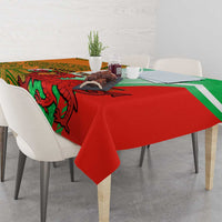 Red and green rugby tablecloth on dining table with patterned creature print and white stripes