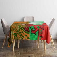 Red and green rugby tablecloth on table with corner fold showing creature motifs