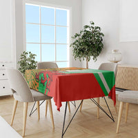 Red and green rugby tablecloth with bold tribal-style creature print and diagonal stripes