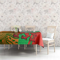Red and green rugby tablecloth on dining set with large creature print and striped edge