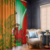Rugby window curtain set, orange patterned panel and green-red dragon panel on rails