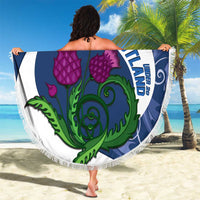 Round beach blanket with blue-and-white crest, purple thistles, green banner, white fringe