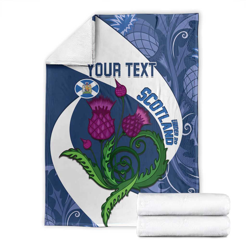 Folded blue and white rugby blanket featuring thistle artwork and Scotland text