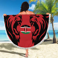 Fringed red round beach blanket with black lion graphics and Kenya emblem in center