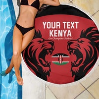 Red round beach blanket with black lion design, Kenya emblem, and white fringed border