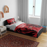 Red and black duvet cover with lion graphic and Kenya text, on bed with two pillows.