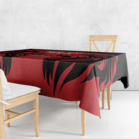 Red and black patterned tablecloth draped over a dining table