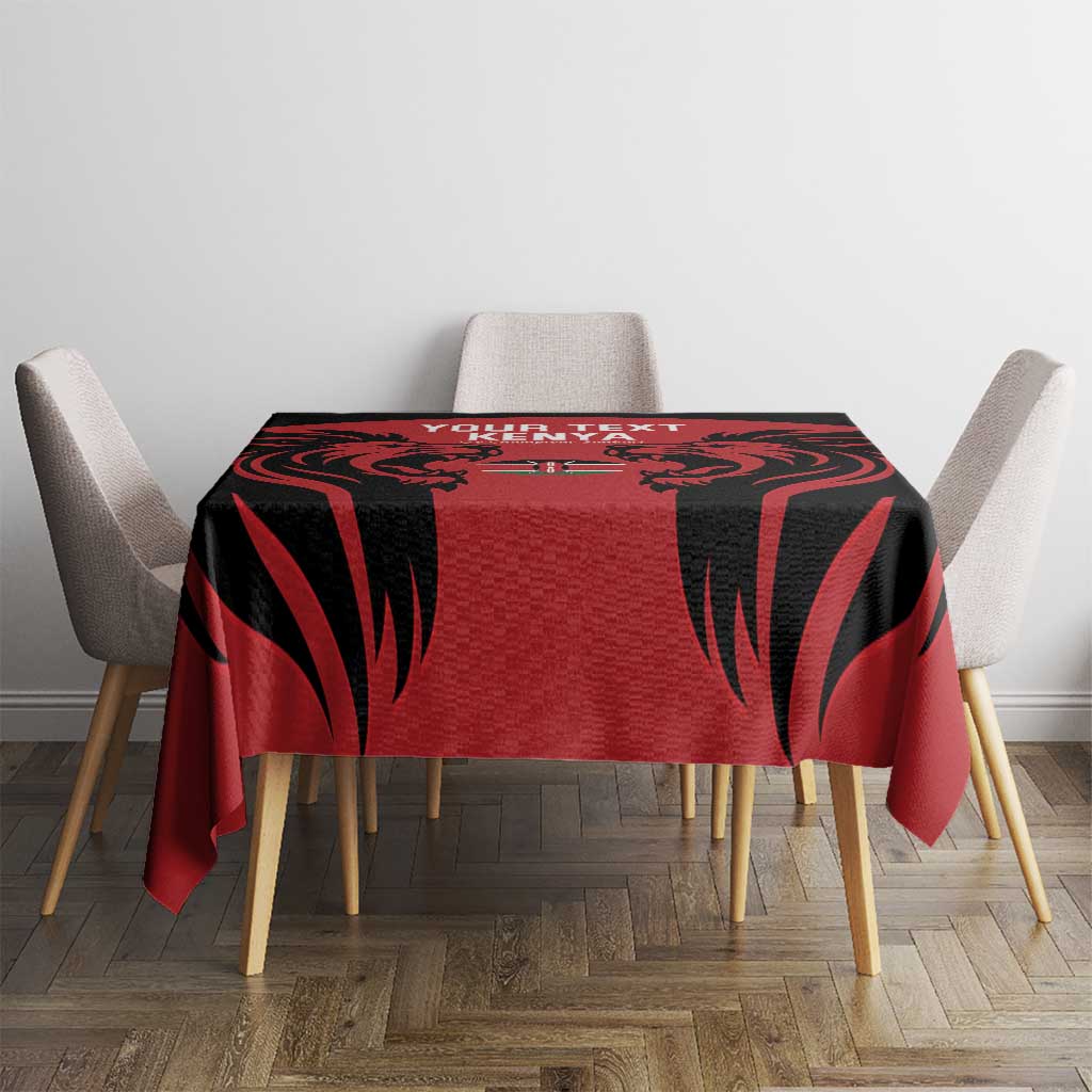 Red tablecloth with black feather-like pattern and centered Kenya text
