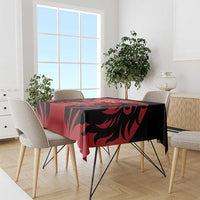 Red and black rugby tablecloth with winged graphic design on dining table