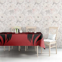 Red and black patterned tablecloth on a dining table with matching design