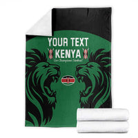 Green Kenya rugby blanket with black border and lion graphic, with folded white stacks