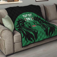 Quilted quilt draped over sofa: black backing with green lion emblem and Kenya text