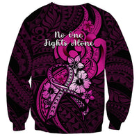 Black sweatshirt with pink Polynesian ribbon and “no one fights alone” back graphic
