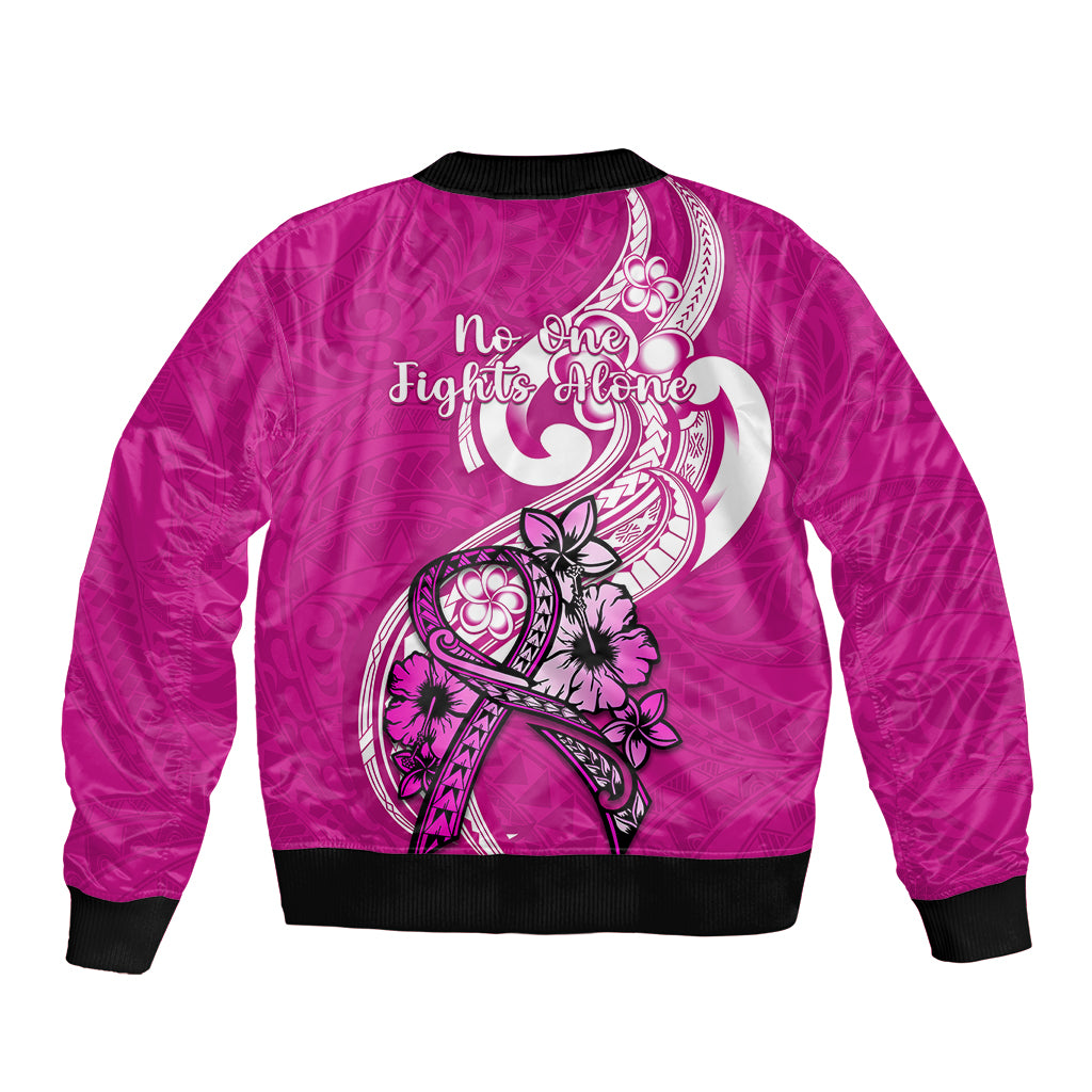 Pink bomber jacket back with black ribbed hem and white ribbon floral design, 'No one fights alone'