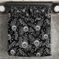 Black bedding set with white pine/leaf print and round crest emblems