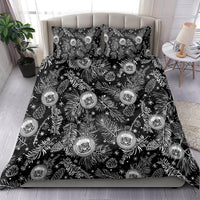 Black bedding set with matching pillow featuring white pine/leaf print and crest emblems