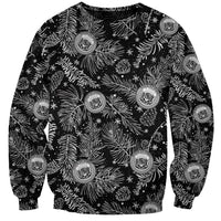 Black crewneck sweatshirt with white tropical holiday pattern and round crest emblems