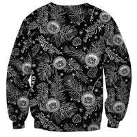 Black crewneck sweatshirt showing white foliage, snowflakes, and round crest print