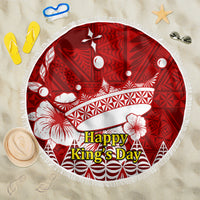 Red round beach blanket with white floral and geometric patterns, tassel fringe edge