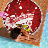 Red round beach blanket with white patterns and tassel fringe, laid flat at an angle
