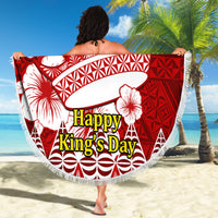 Red round beach blanket with white geometric pattern and tassel fringe, held outward