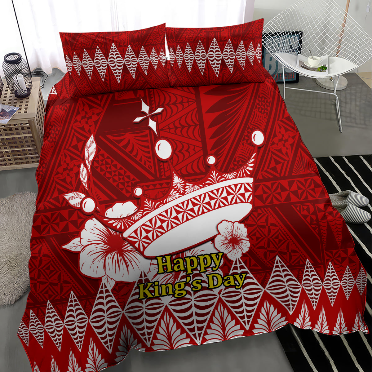 Red comforter with Tonga Ngatu crown motif and 'Happy King's Day' lettering, floral accents