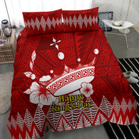 Red comforter with Tonga Ngatu crown motif and 'Happy King's Day' lettering, floral accents
