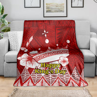 Red throw blanket with Happy King’s Day text and white crown motifs on geometric pattern