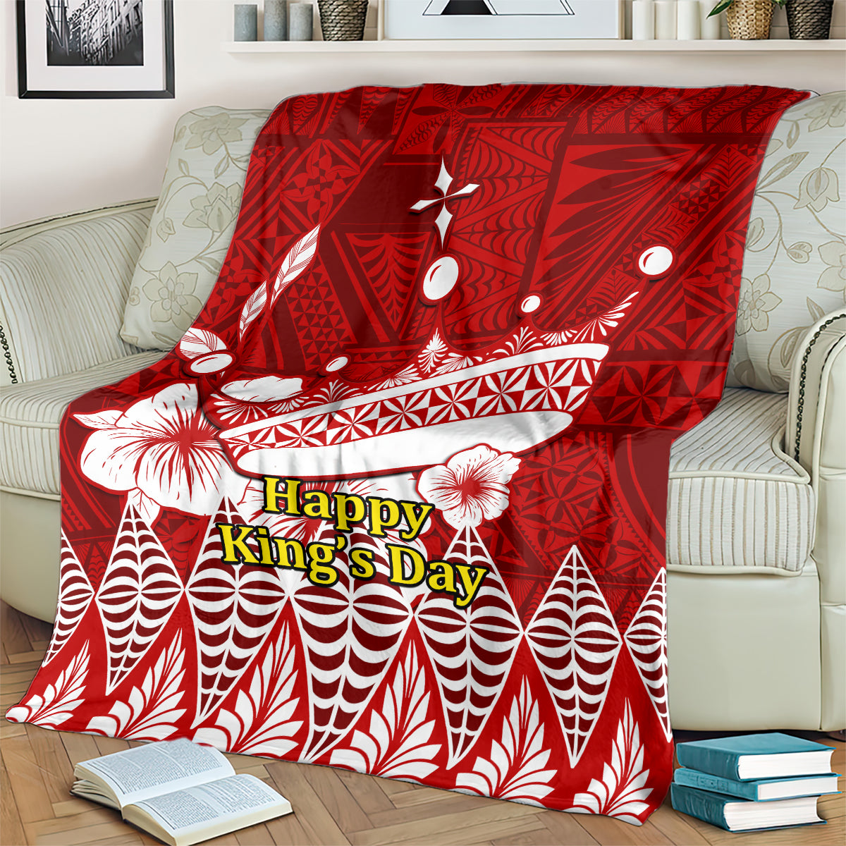 Red blanket draped on a sofa featuring Happy King’s Day lettering and white decorative elements