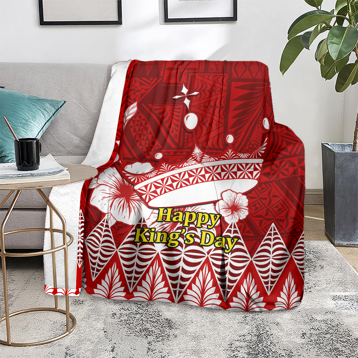 Red throw blanket featuring Happy King’s Day text and white crown, shell, and leaf motifs