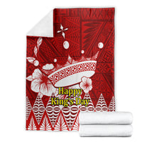 Folded red blanket with Happy King’s Day text, white crown motif, and geometric Tongan pattern