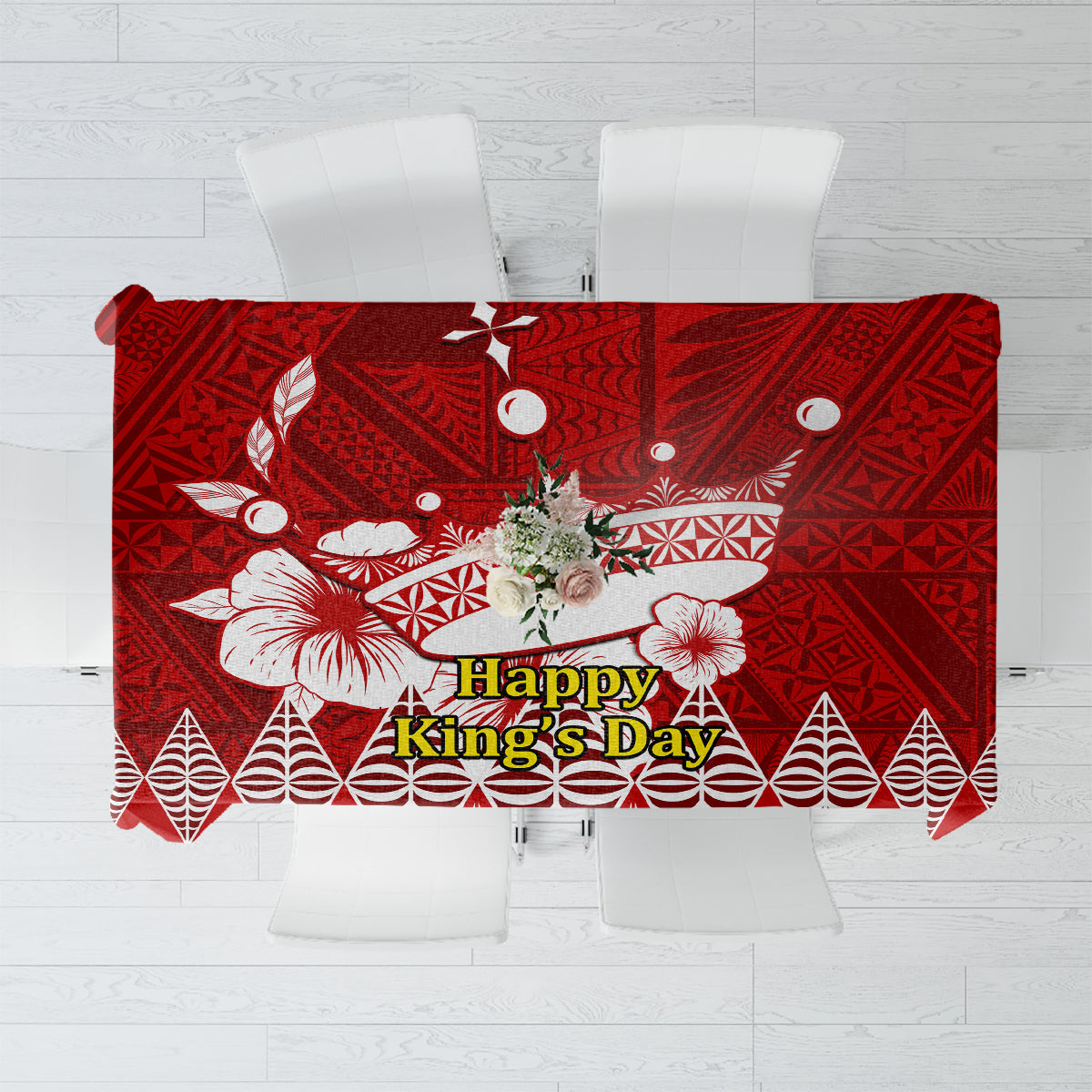 Red tablecloth with white Tongan-style geometric and floral motifs, centered text panel