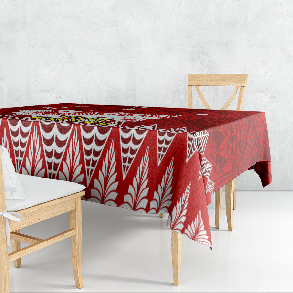 Red tablecloth with white wave and leaf motifs, draped over dining table