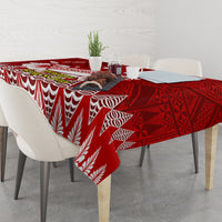 Red tablecloth with white wave and leaf motifs, corner drop over dining table