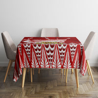 Red tablecloth with white teardrop and leaf pattern, neatly covering dining table