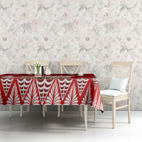 Red tablecloth with white teardrop and leaf motifs, on dining table