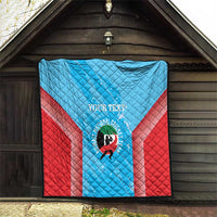 Cricket quilt hanging on wall: light blue and red design with custom text and team logo