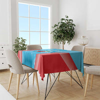 Blue tablecloth with red edge drape and cricket graphic, styled on a dining table