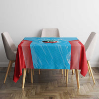 Blue and red cricket tablecloth covering a small dining table with four chairs
