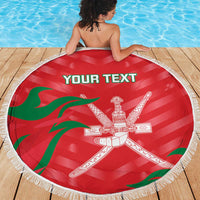Red round Oman-themed beach blanket with white fringe, Oman crest and custom text