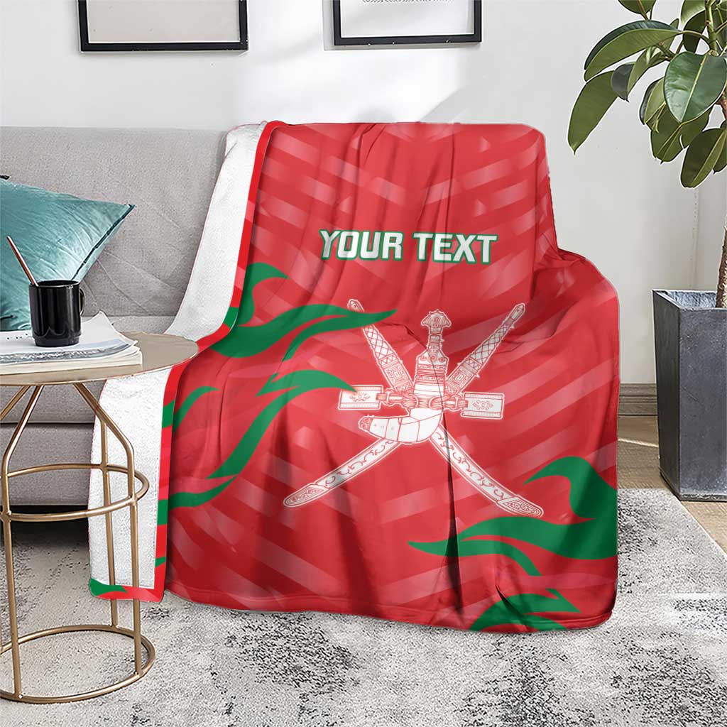 Red custom cricket blanket on floor with green flag stripes and crossed swords emblem