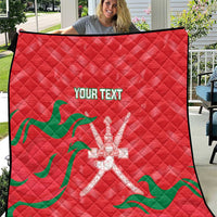 Red quilt blanket with green wave pattern and white emblem, custom text centered