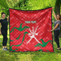 Red quilt blanket with green wave pattern and white emblem, custom text on front