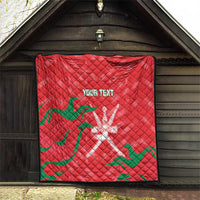 Red quilt blanket with green wave pattern and white emblem, custom text on wall