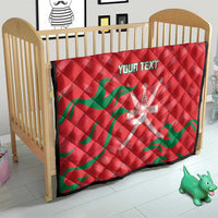 Red quilt blanket with green wave pattern and white emblem, custom text on crib